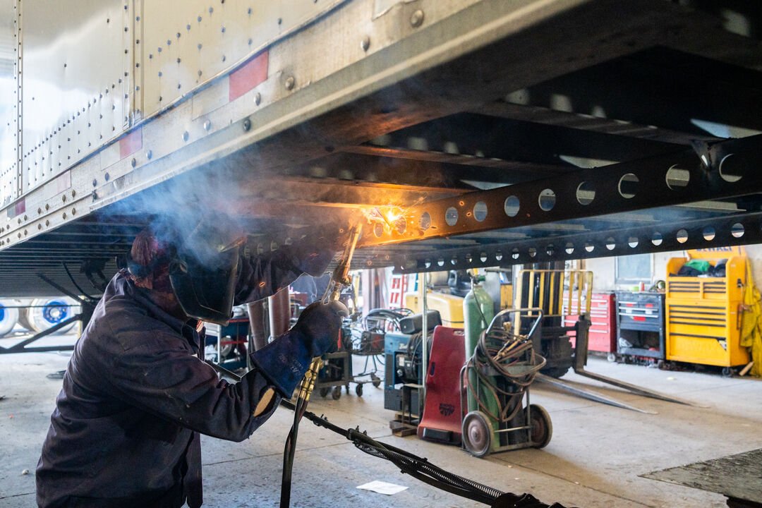 Mobile trailer repair technician working under trailer in Houston TX